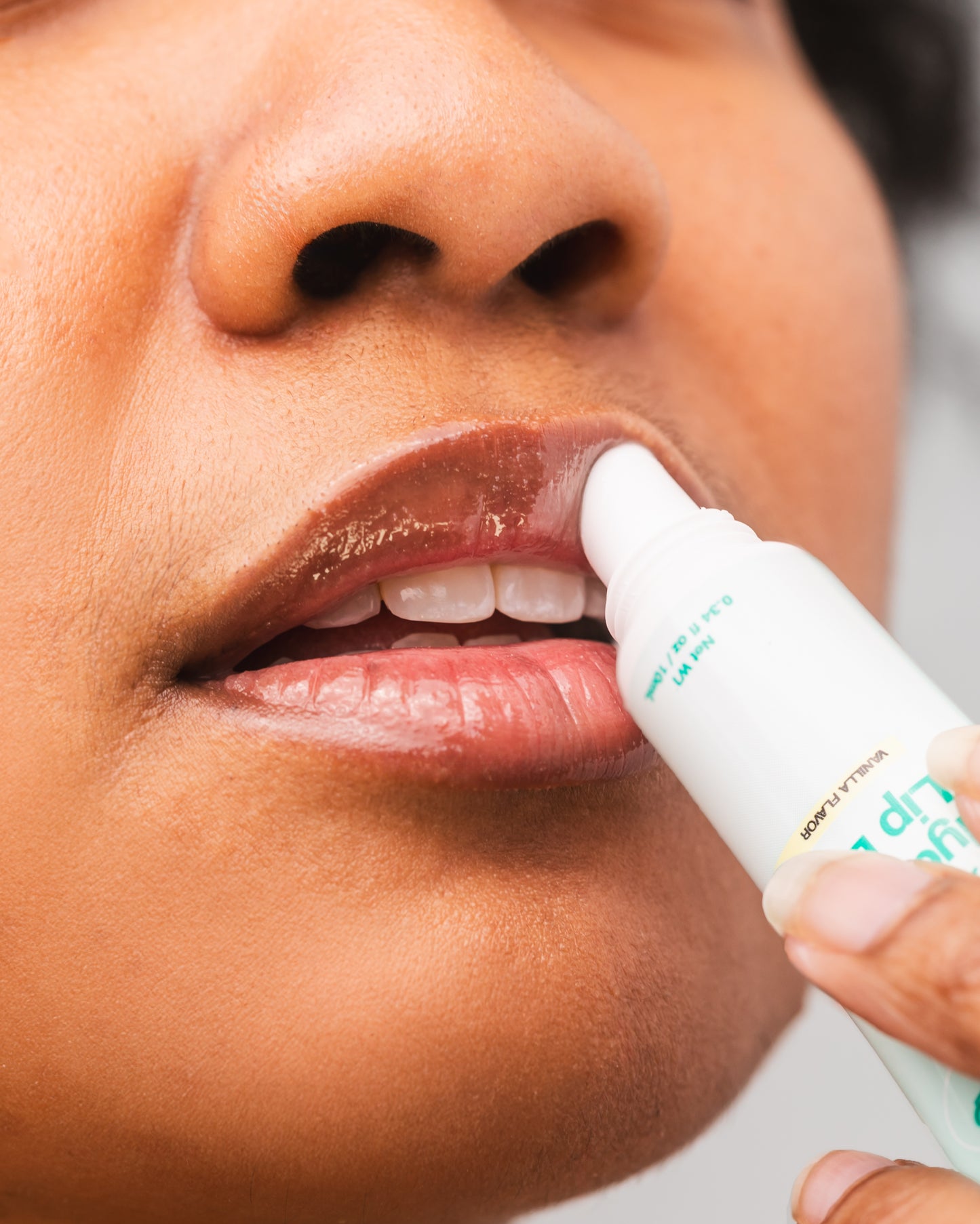 Close-up of model using Everytime lip balm for soft, moisturized lips